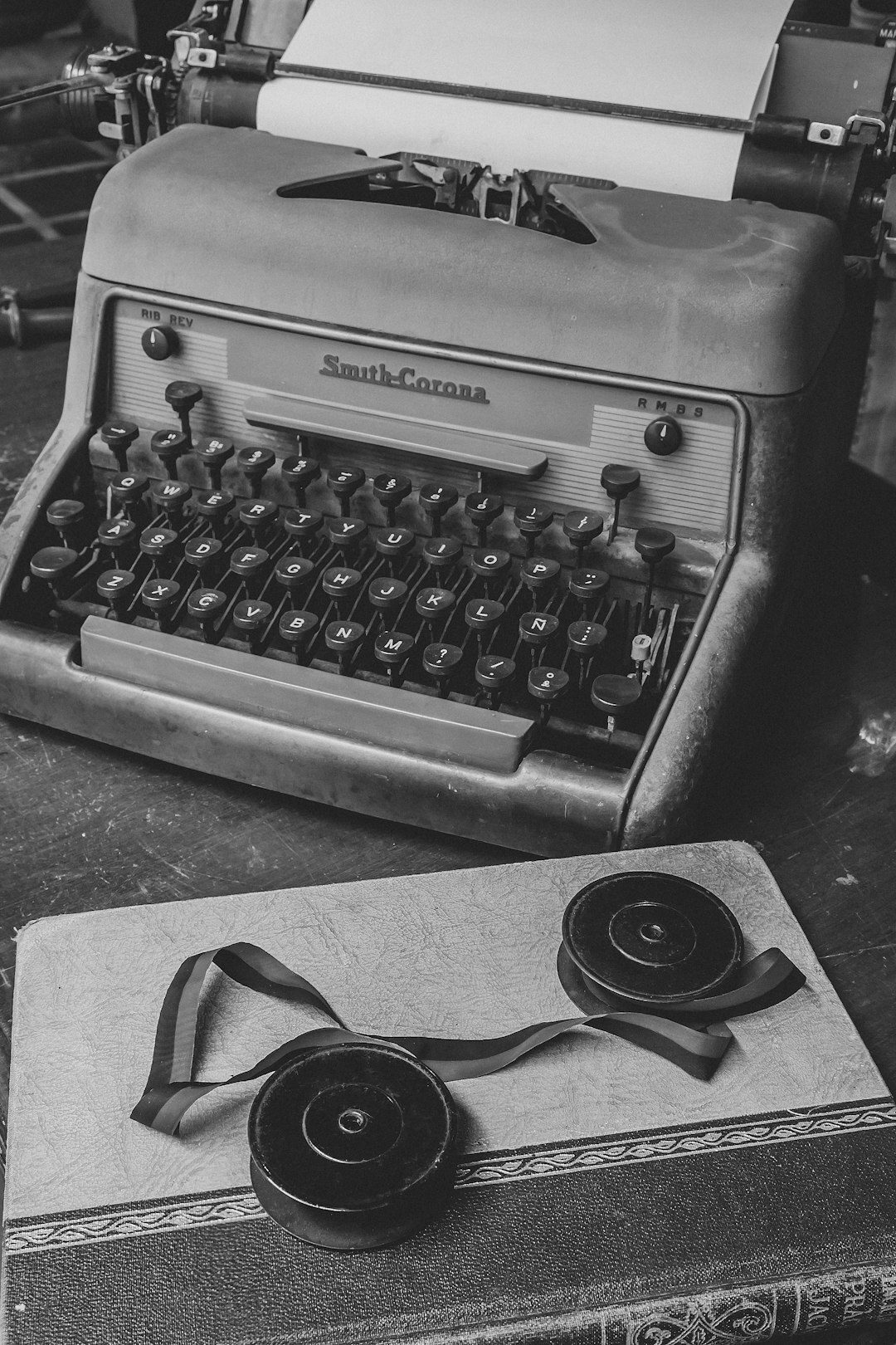 Vintage typewriter with archival photographs and film reels